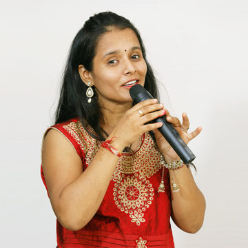 woman with mic in red dress singing